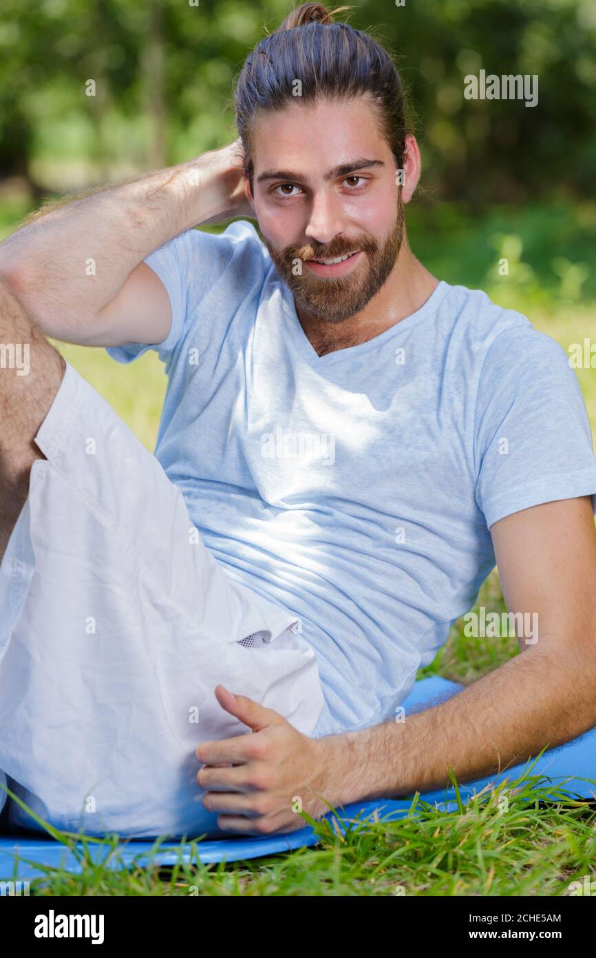 man doing abdominal exercises on mat outdoors Stock Photo Alamy