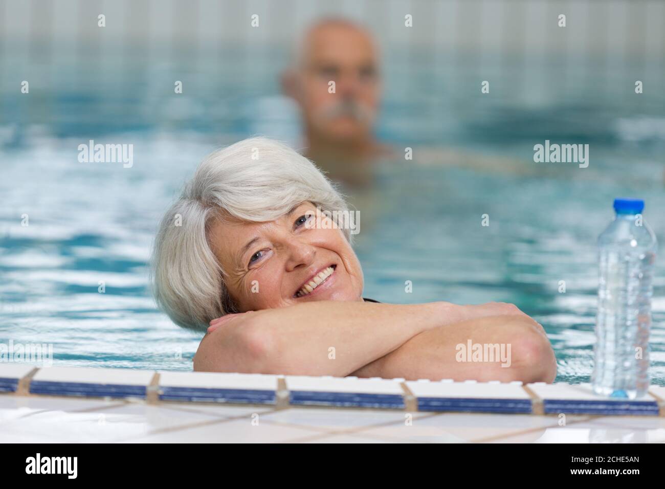 Older woman swimming in pool hi-res stock photography and images - Alamy
