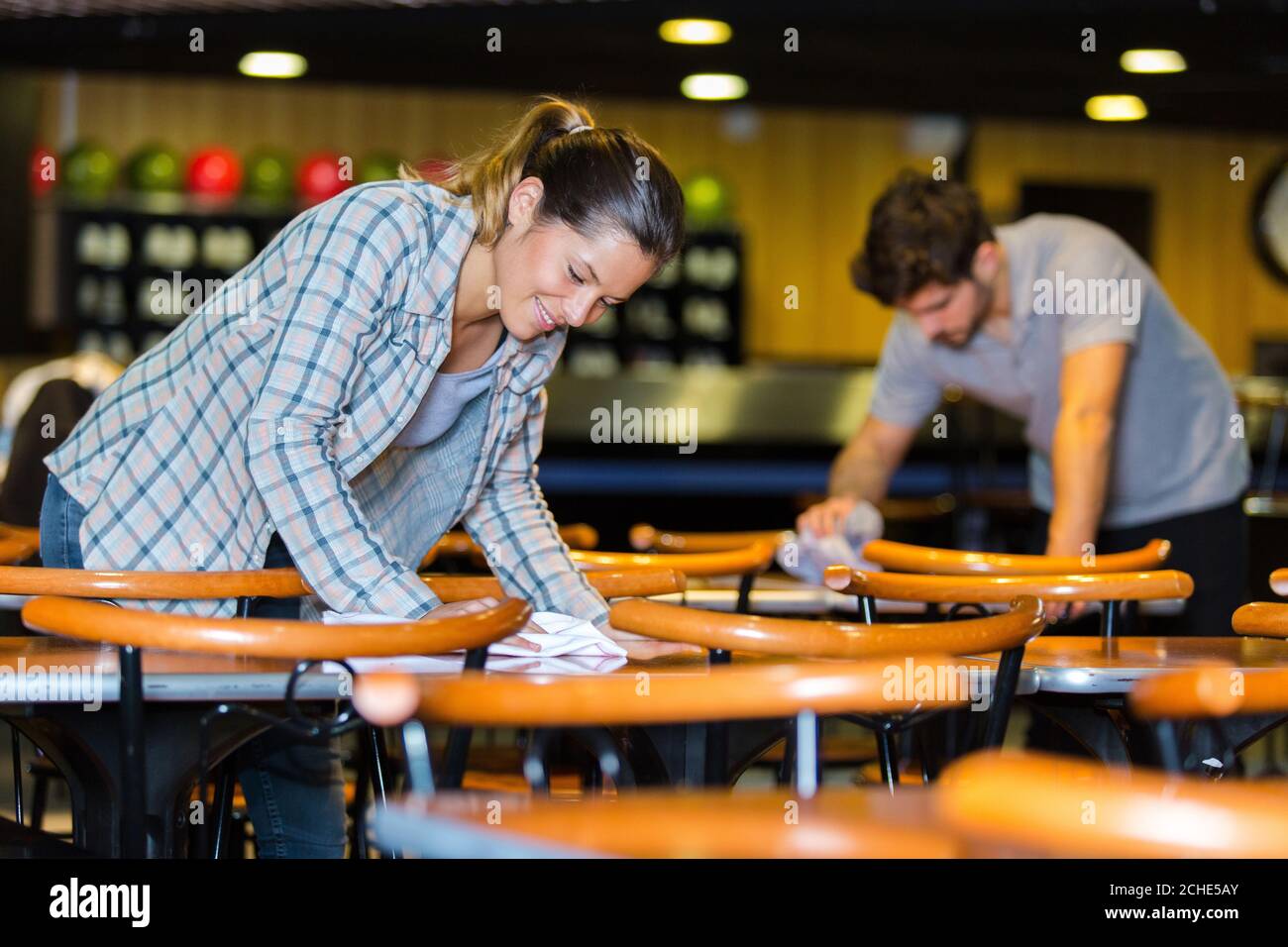 male and female worker cleaning bar Stock Photo