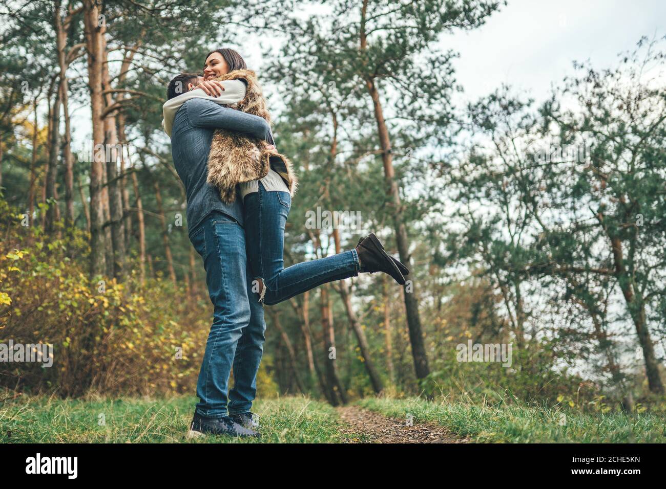 Pretty young couple walking together in the forest Stock Photo - Alamy