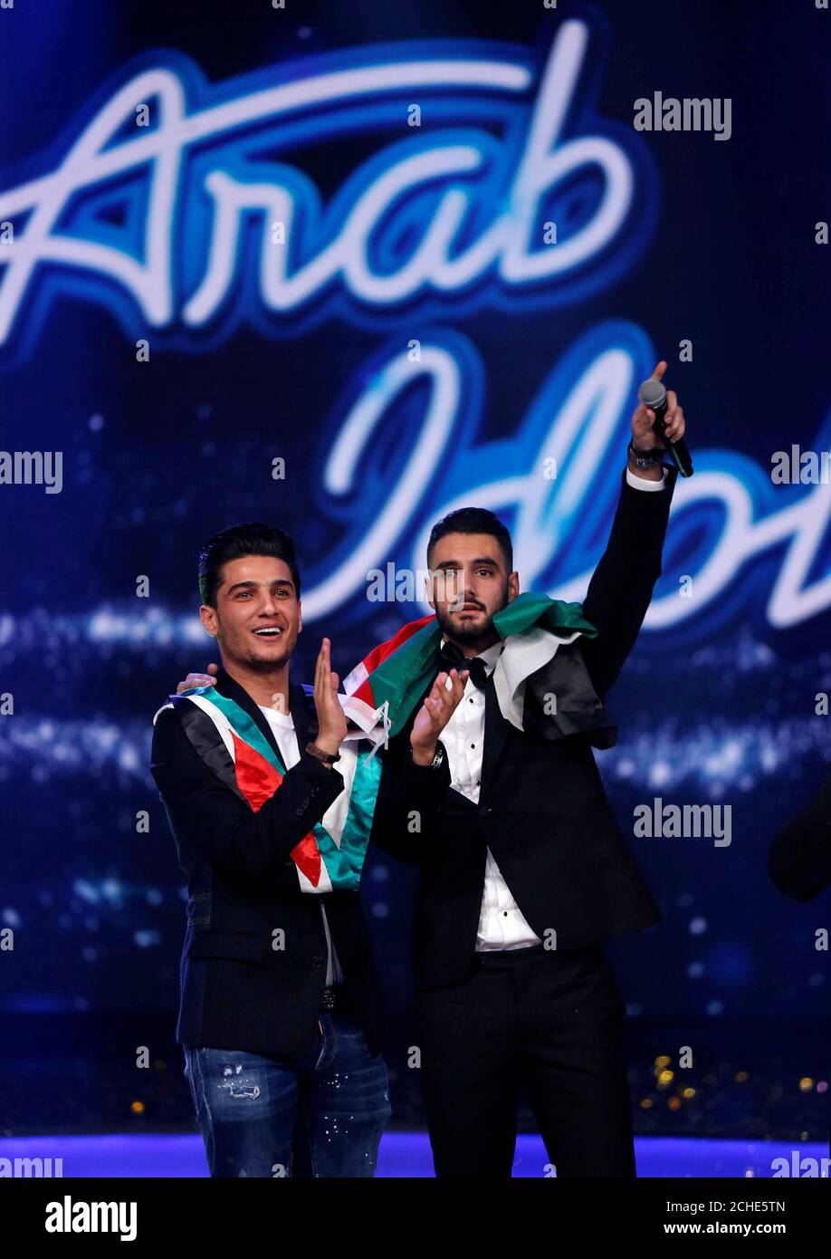 Palestinian Singer Yaqoub Shaheen R Winner Of Arab Idol Season 4 Gestures As He Stands Next To Palestinian Singer Mohammed Assaf Winner Of The Second Season Of Arab Idol During The Final