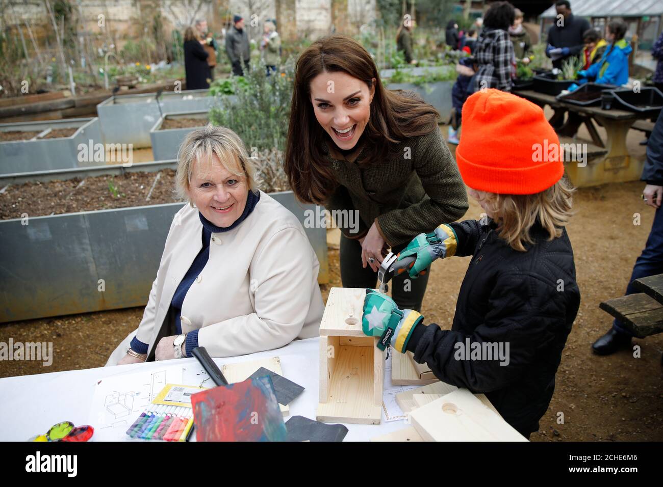 The Duchess of Cambridge helps make bird boxes during a visit to the King Henry's Walk Garden in Islington, London to learn about a project bringing people together through a shared love of horticulture. Stock Photo