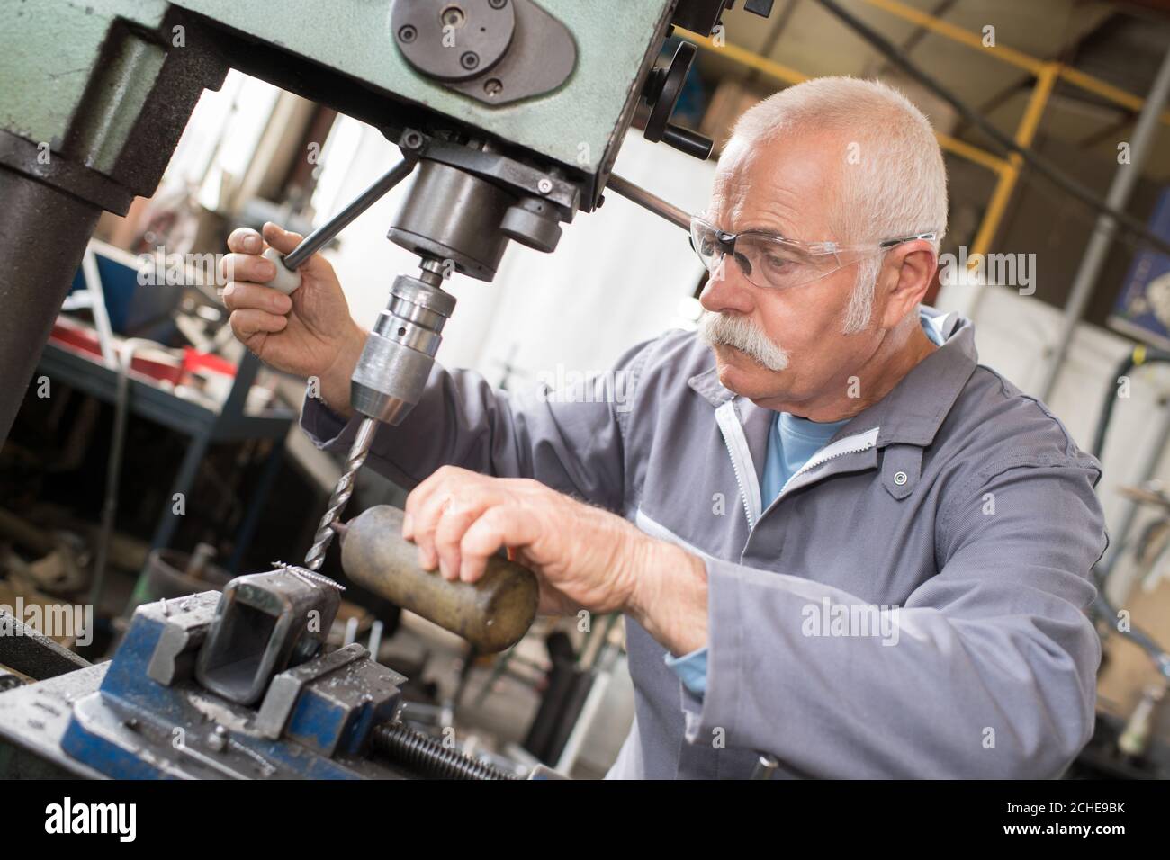 senior operator works at machine Stock Photo