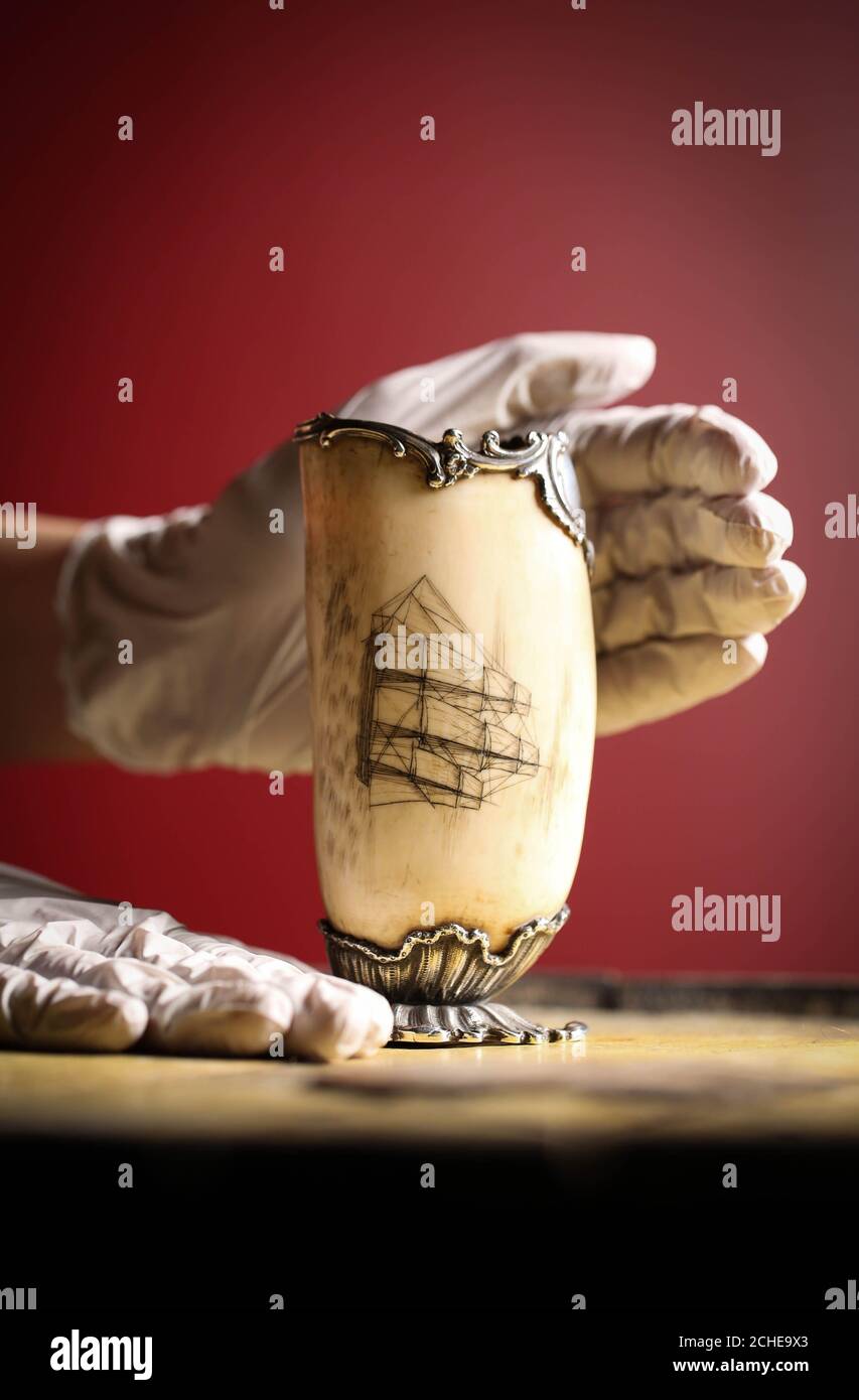 EDITORIAL USE ONLY A decorated whale's tooth, an example of the art of scrimshaw, produced in 1837 by Alexander Munro goes on display for the first time in the City and River gallery at the Museum of London Docklands. Stock Photo