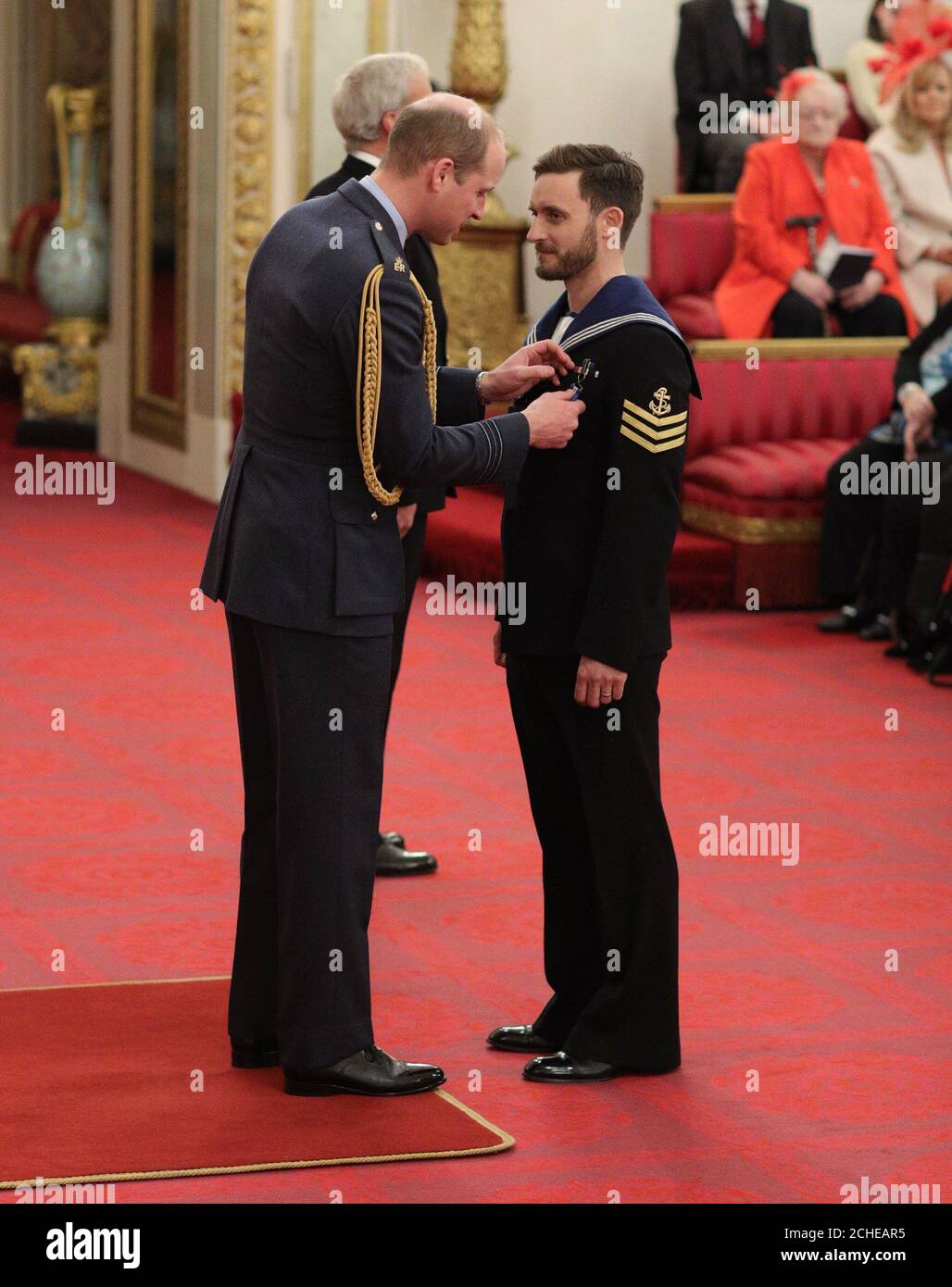 Leading Seaman (Diver) Simon Wharton, Royal Navy, is decorated with the Queen's Gallantry Medal by the Duke of Cambridge, during an Investiture ceremony at Buckingham Palace, London. Stock Photo