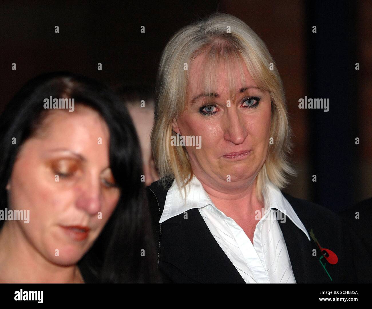 Amanda Carter listens as her sister Tracey Cooper reads a statement on her behalf at Stafford Crown Court after Mark Goldstraw was found guilty of murdering four members of her family in an arson attack. Stock Photo