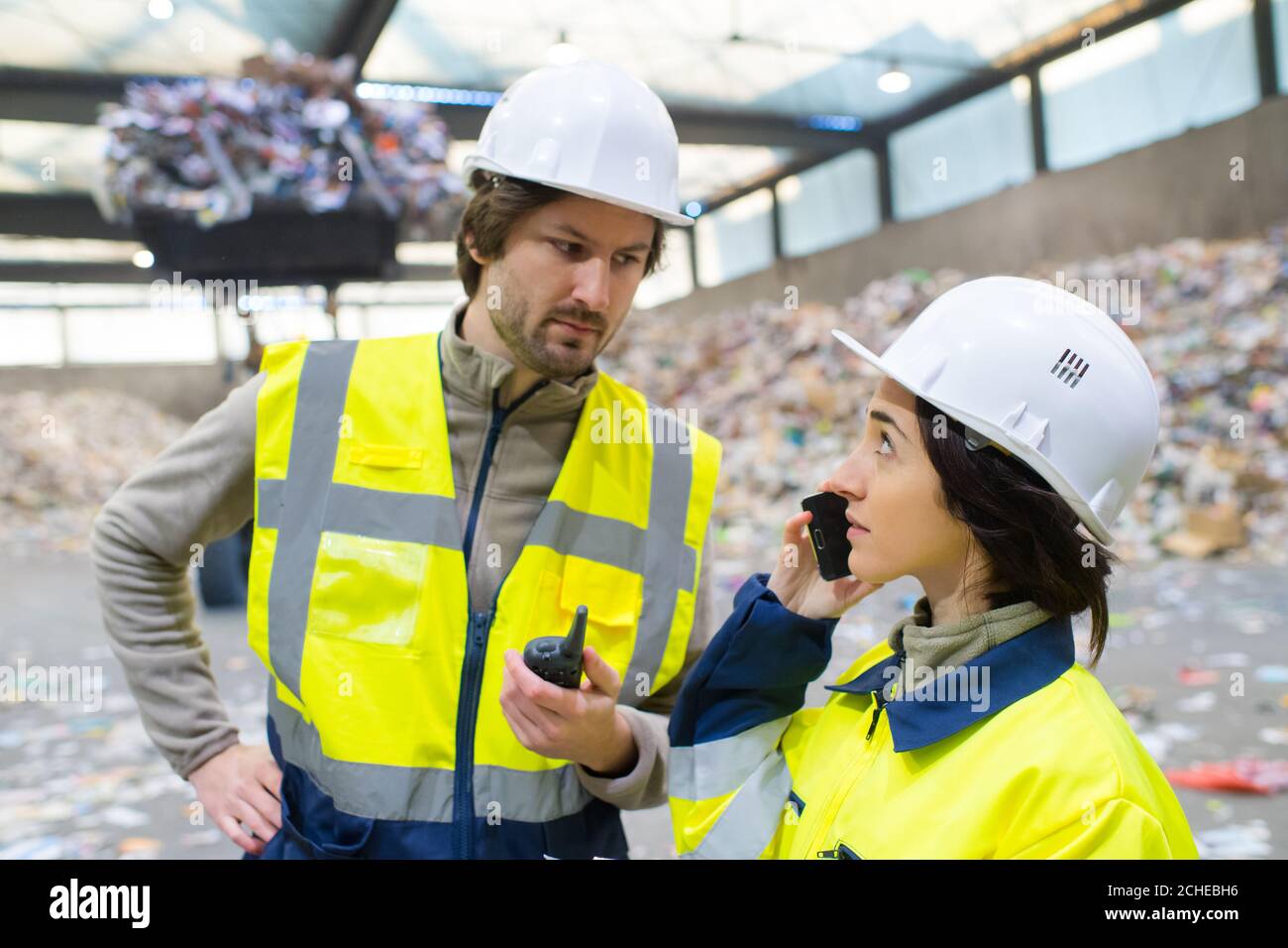 manager and worker talking in recycling plant Stock Photo