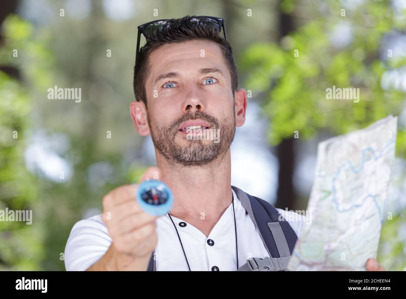 man orienteering in woodlands with map and compass Stock Photo - Alamy