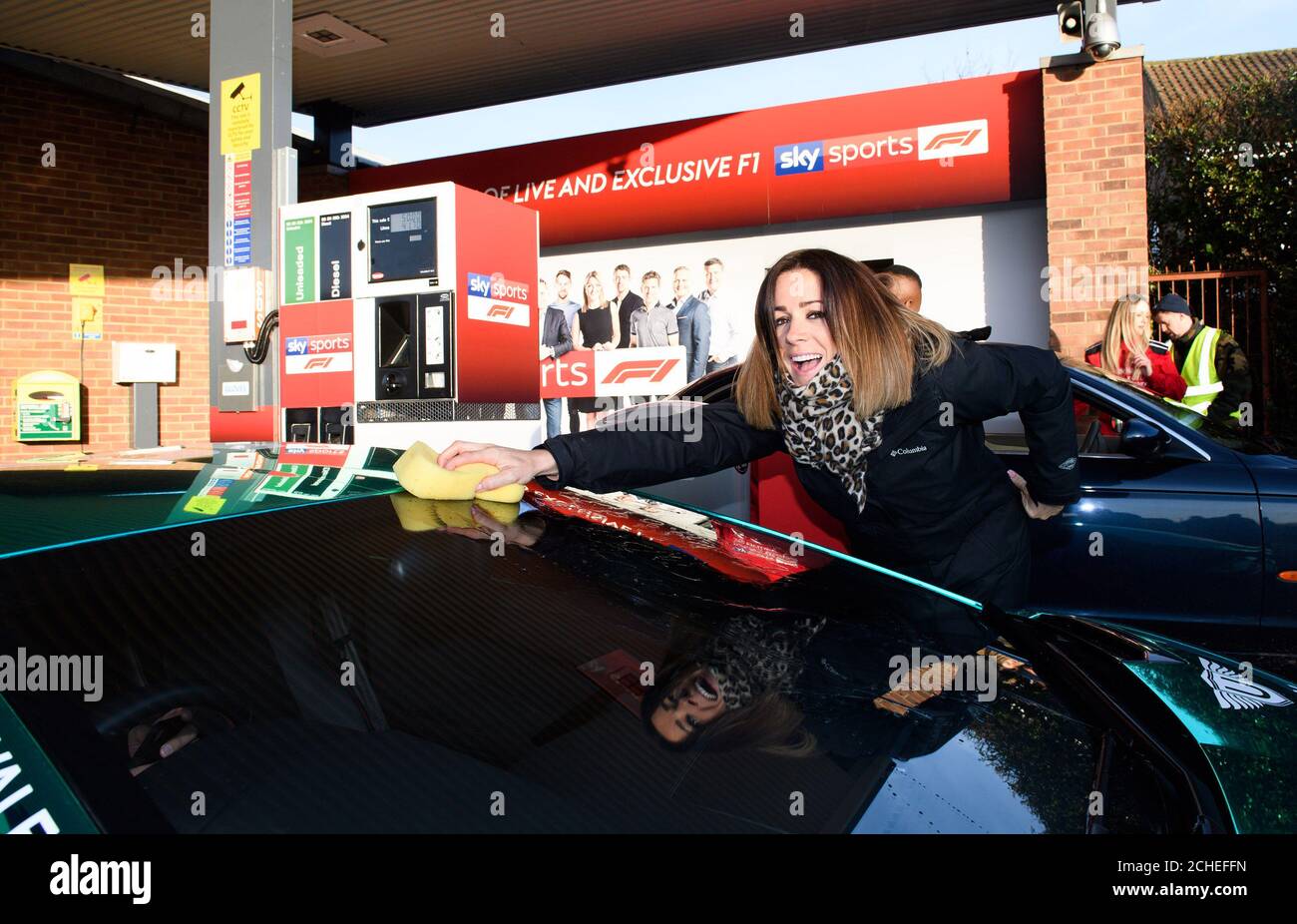 EDITORIAL USE ONLY Natalie Pinkham, pit lane reporter, cleans cars as Sky Sports F1 takes over a garage in High Wycombe in Buckinghamshire, to give drivers the ultimate pit stop experience to