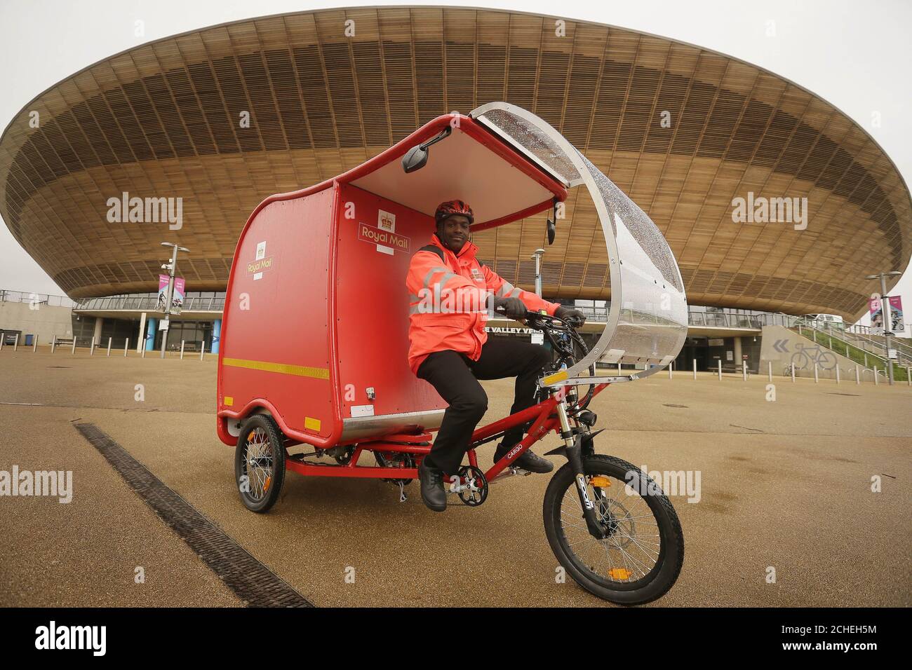 Postman Jude Stirling at the unveiling of the zero-carbon emission e-Trikes, which are predominantly powered by a combination of solar, battery and brake technology, and will be trialled by Royal Mail in Stratford in east London, Cambridge and Sutton Coldfield at the end of the month. Stock Photo