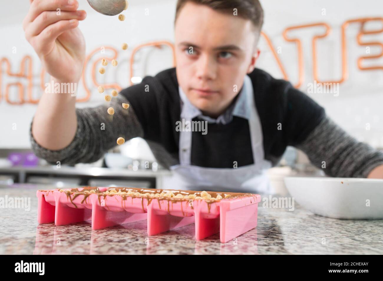 EDITORIAL USE ONLY Callum Clogher, a 17-year-old from Roscommon in Ireland, visits the Cadbury Innovation Kitchen in Bournville, Birmingham, to create his CHOCA-LATTE bar after winning the Cadbury Inventor competition to become one of three winning inventors chosen from the public. Stock Photo