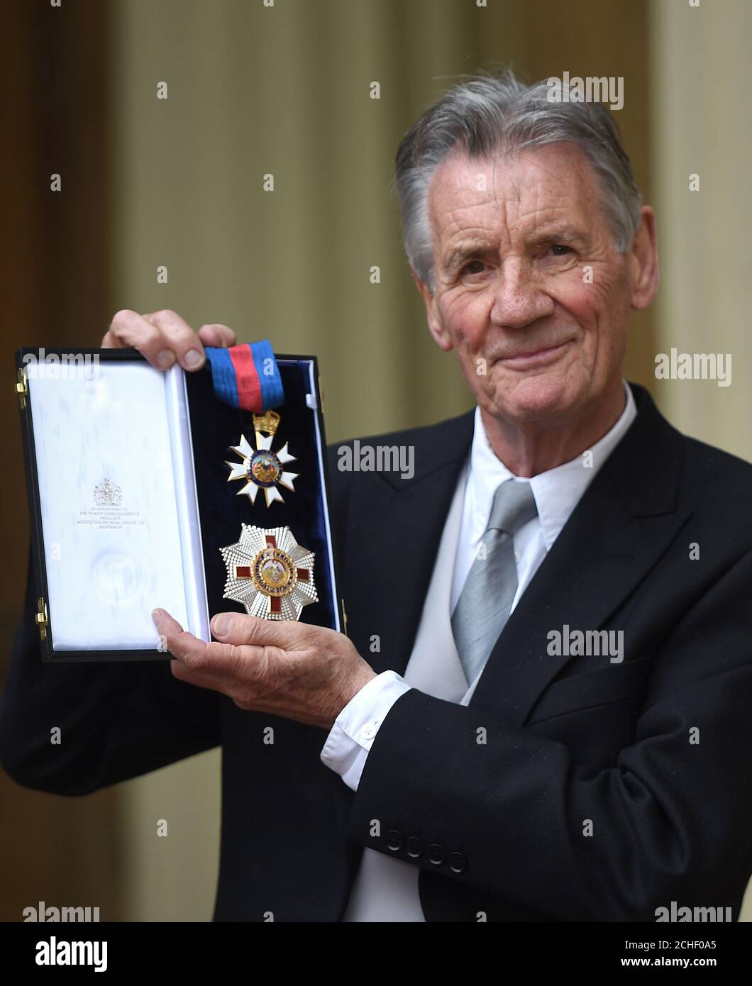 Sir Michael Palin after he was awarded a Knight Commander of the Order of St Michael and St George following an investiture ceremony at Buckingham Palace, London. Stock Photo