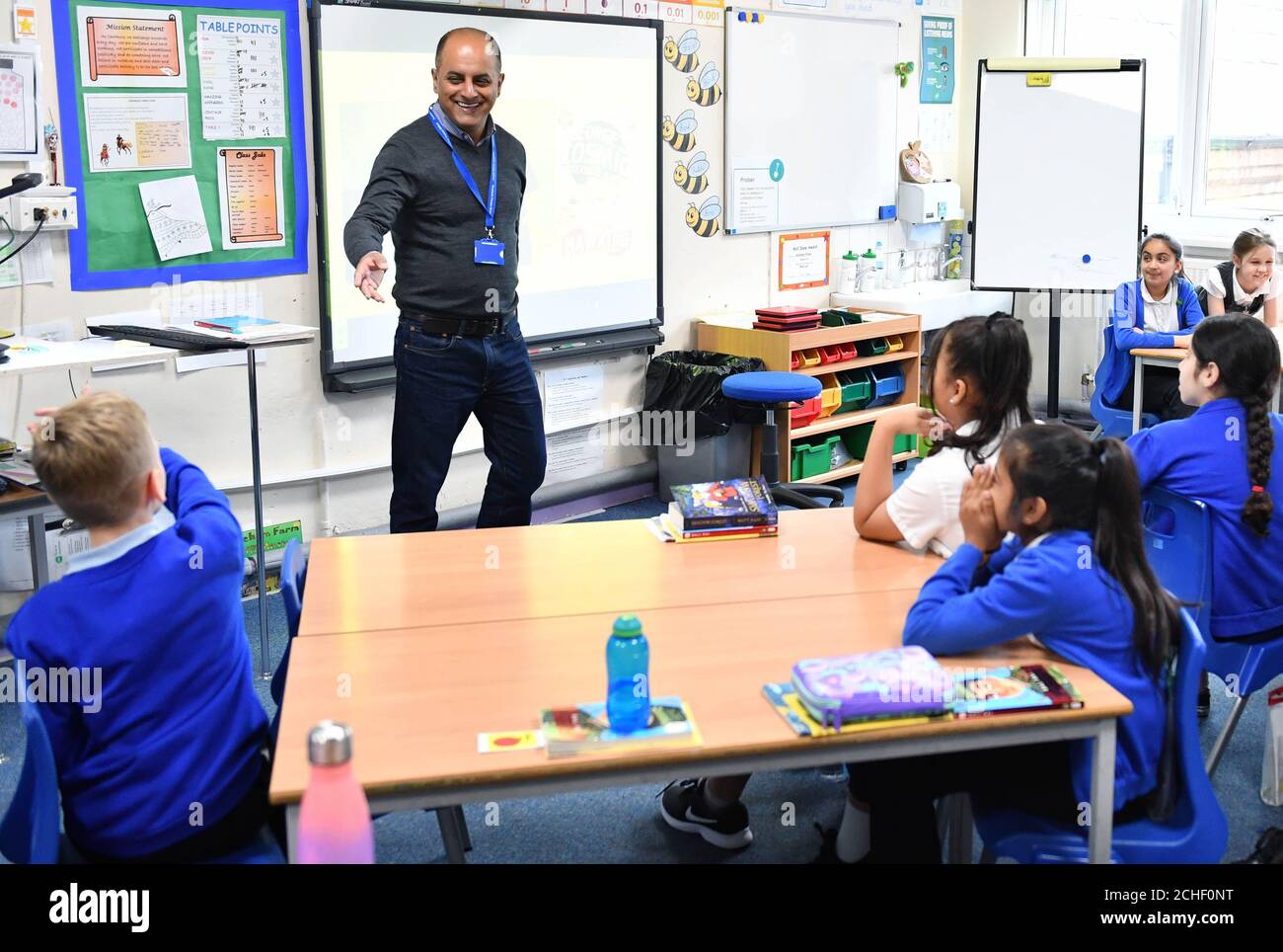 School children at Rosebank Primary School in Leeds meet author Bali Rai at a pop-up book fair, highlighting books by authors and illustrators of colour or those that feature BAME main characters, which has been organised by BookTrust and Scholastics following research that found that less than 2% of published authors and illustrators in the UK are British people of colour. Stock Photo