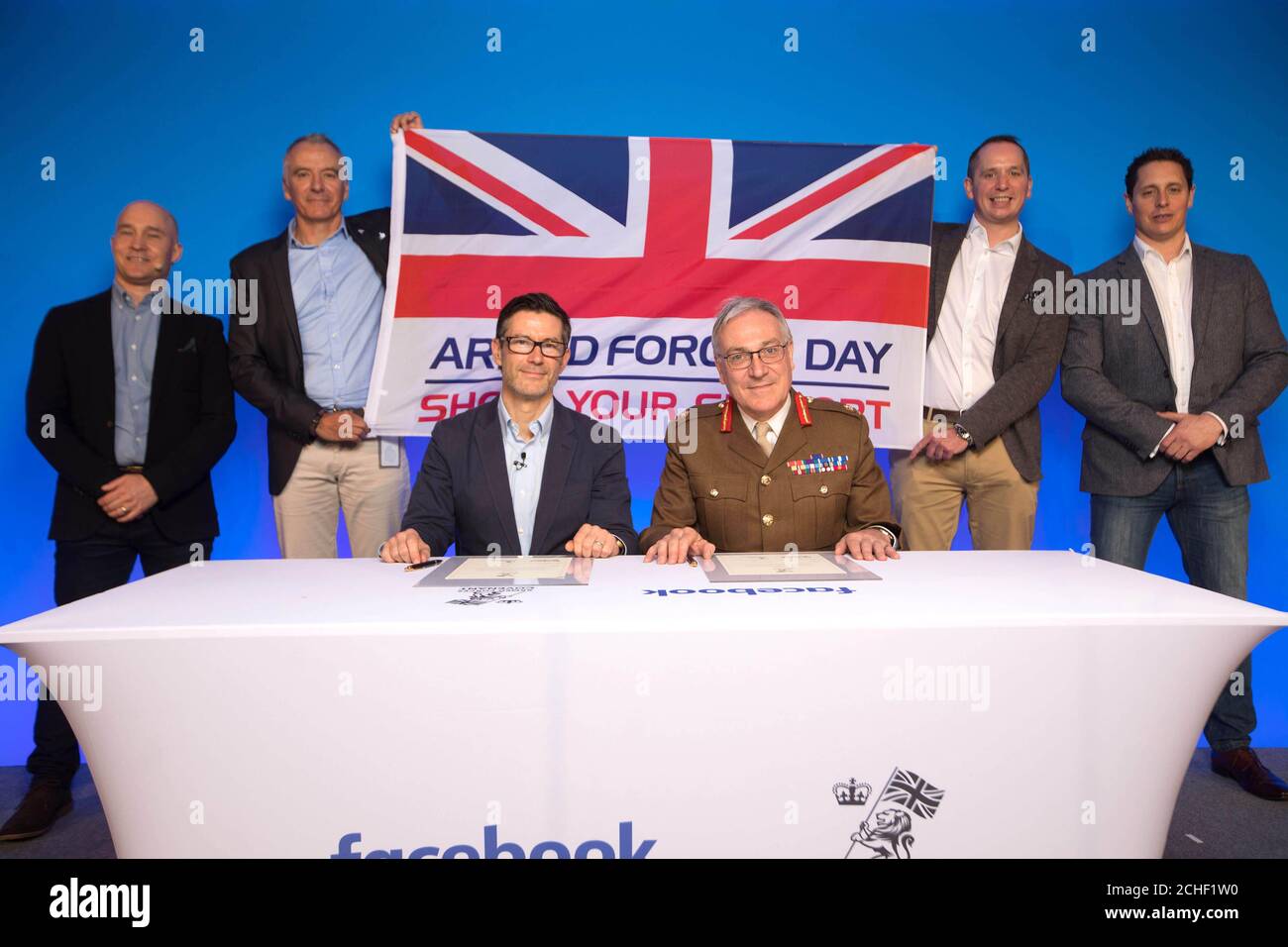 EDITORIAL USE ONLY Lieutenant General Richard Nugee, Chief of Defence People Ministry of Defence, and Steve Hatch, Director UK and Ireland Facebook sign the Armed Forces Covenant with left-right Facebook employees and veterans Andy Mihalop, Chris Jones, David Coles and Robert Scanlan which is a pledge to ensure ex-military personnel are provided with equal opportunities, at the Boost with Facebook for the Armed Forces Community event in London. Stock Photo