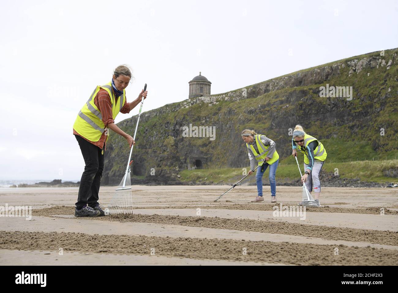 To celebrate the return of golf's original championship to Northern Ireland after 68 years, Tourism Ireland has collaborated with sand artists, Sand in your Eye, to create five pieces of sand art on the beach at Downhill Strand ahead of The 148th Open. PRESS ASSOCIATION. Issue date: Thursday July 4, 2019. The artworks depict Titanic Belfast, The Dark Hedges and House Stark's Direwolf Sigil from Game of Thrones, Derry-Londonderry's Guildhall and native champion golfer Rory McIlroy. Photo should read: Michael Cooper/PA Wire Stock Photo