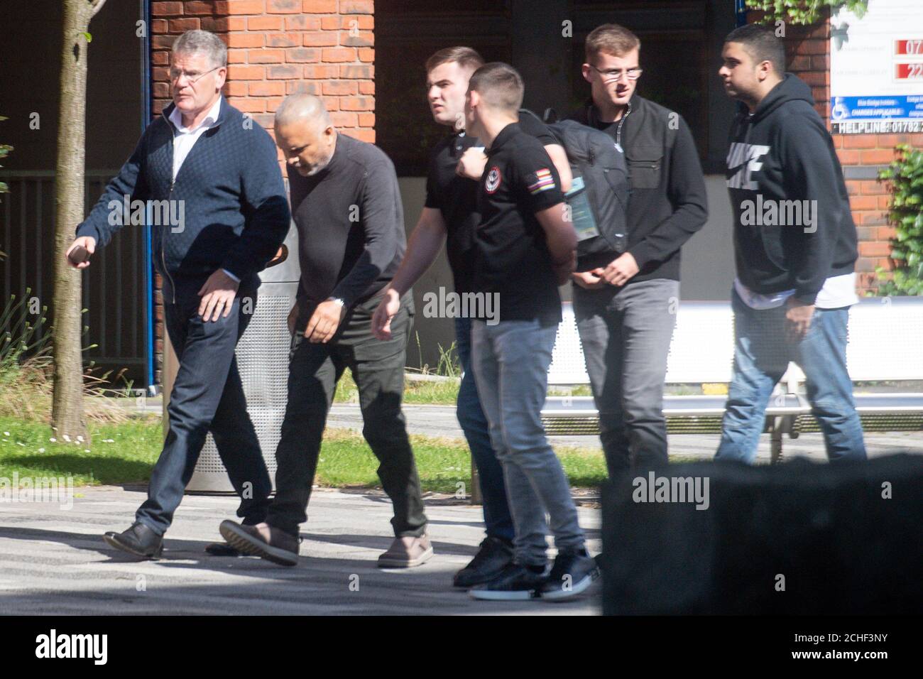 Irish businessman Thomas Kavanagh (far left), after leaving Stoke-on-Trent Crown Court, as the jury has retired to consider its verdict in his trial where he is accused of having a "10,000-volt" stun gun disguised as a torch in his house. Stock Photo