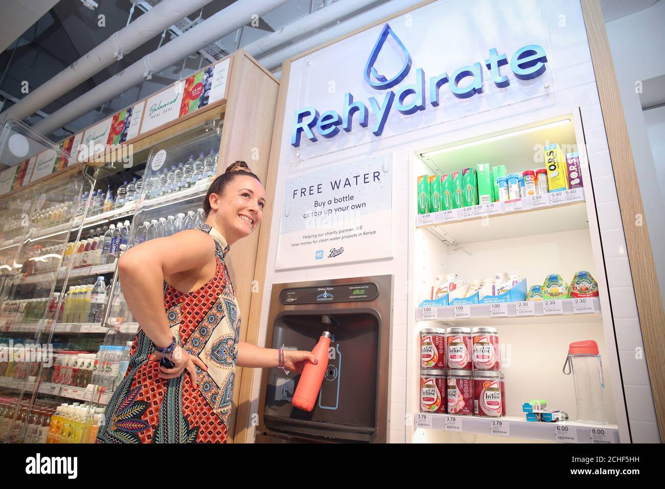 Editorial Use Only Customers Fill Up Water Bottles At The Free Rehydration Station At Boots Store In Covent Garden London Stock Photo Alamy