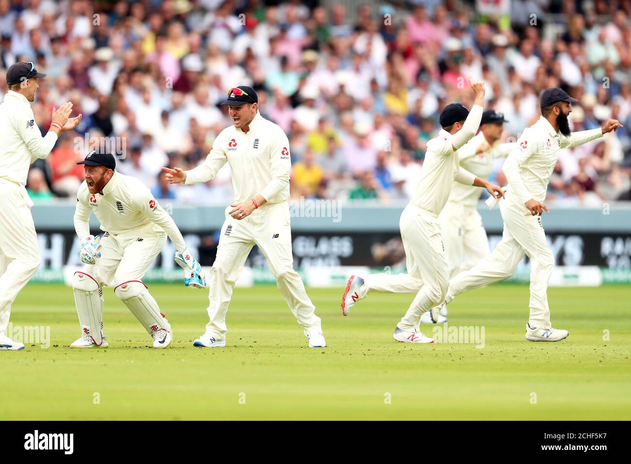 England's Jonny Bairstow (second left) celebrates the catch of Ireland's William Porterfield with team-mates during day three of the Specsavers Test Series match at Lord's, London. Stock Photo