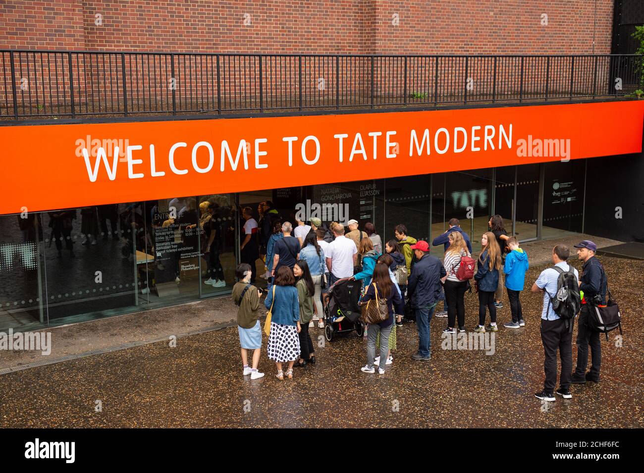 Members of the public queue to enter the Tate Modern art gallery in London, following the arrest of a 17-year-old male on suspicion of attempted murder after a six-year-old boy was thrown from the tenth floor viewing platform on Sunday. Stock Photo