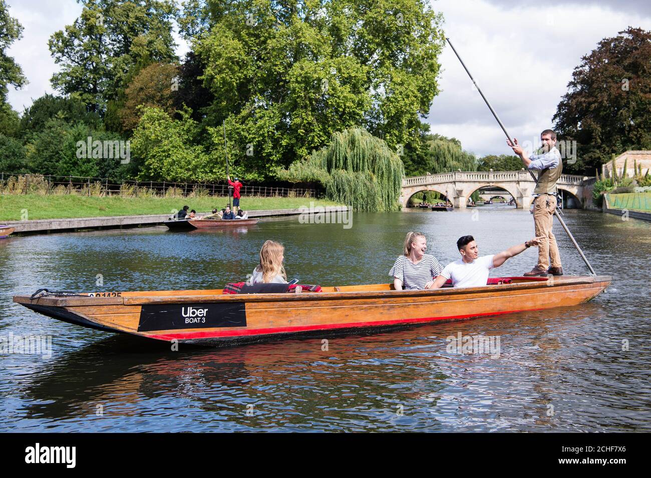 (Left to right) Jess Smith, Kate Mahoney and George Palmer from London onboard an Uber Boat as the service arrives in Cambridge in time for the bank holiday weekend. Stock Photo