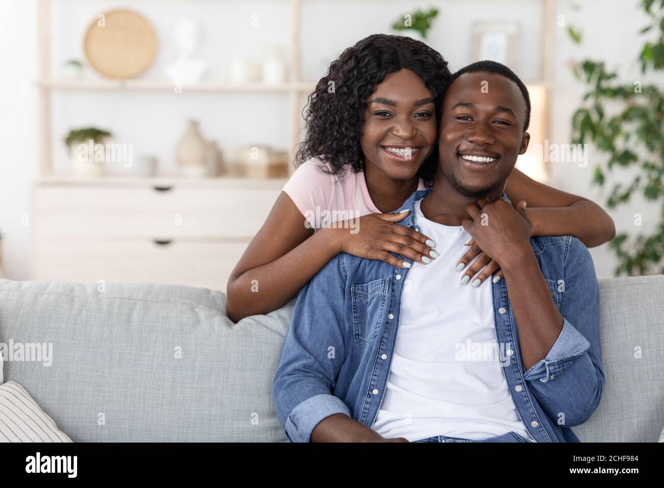 Happy african woman hugging her husband from behind Stock Photo - Alamy