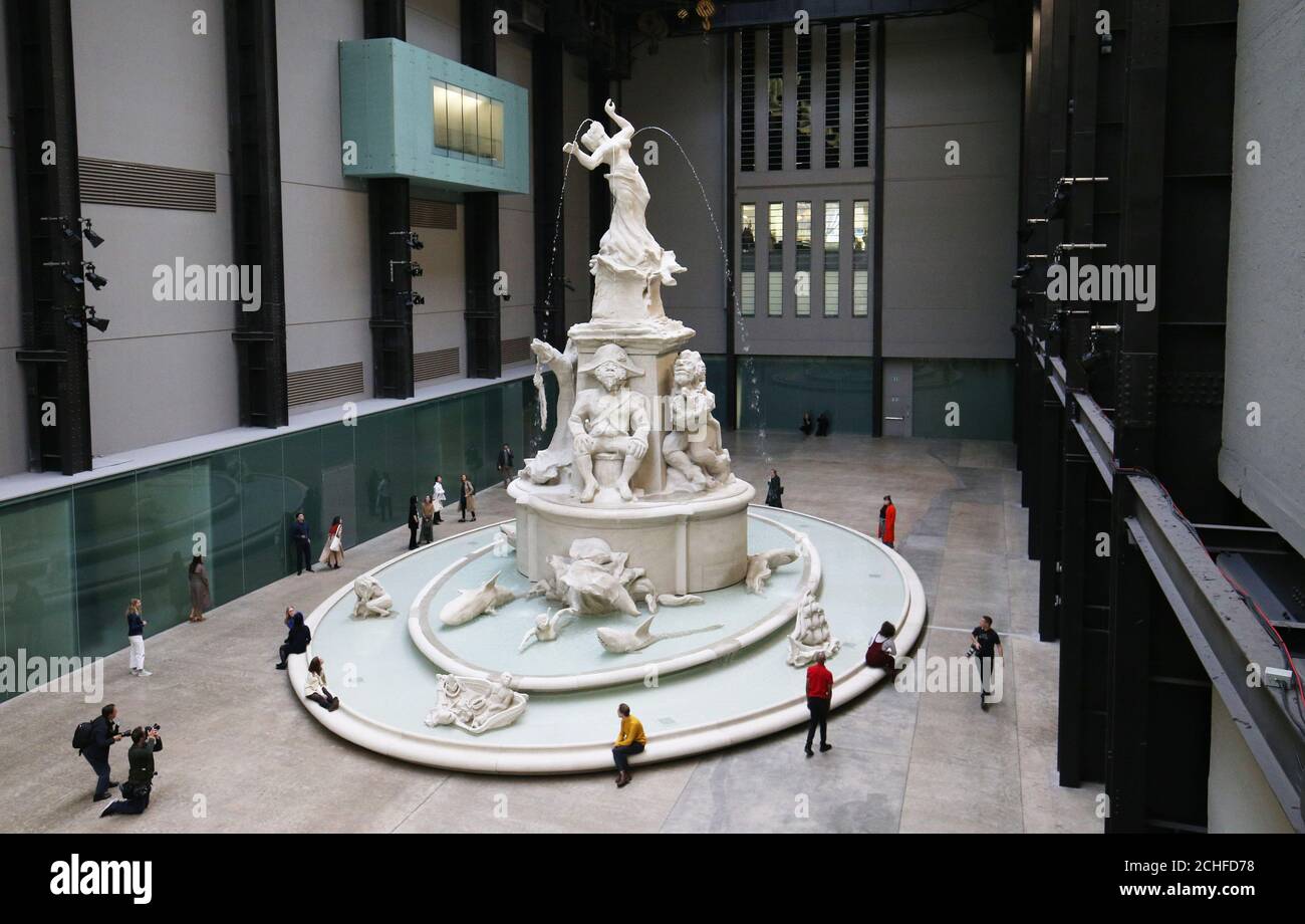 New York-based artist Kara Walker's new Hyundai Commission work Fons Americanus is unveiled during a media event in London's Tate Modern Turbine Hall. Inspired by the Victoria Memorial in front of Buckingham Palace, the thirteen metre high fountain is adorned by depictions of characters from art historical, literary, and cultural sources and presents an origin story of the African diaspora. Stock Photo