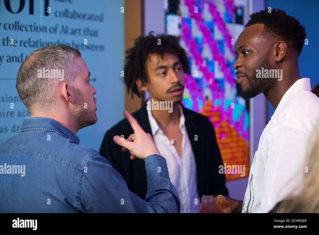 EDITORIAL USE ONLY Russell Tovey talking with Jordan Stephens and Yinka Ilor at the Bombay Sapphire Stir Creativity Lounge at Frieze London, where the gin brand is launching a new Artificial Intelligence art collection in collaboration with artist Yinka Ilori. Stock Photo