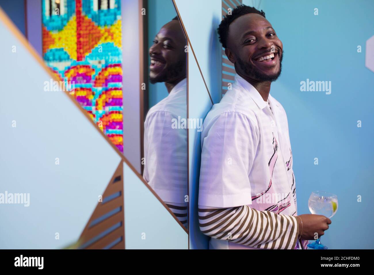 EDITORIAL USE ONLY Yinka Ilori with his artwork at the Bombay Sapphire Stir Creativity Lounge at Frieze London, where the gin brand is launching a new Artificial Intelligence art collection in collaboration with artist Yinka Ilori. Stock Photo