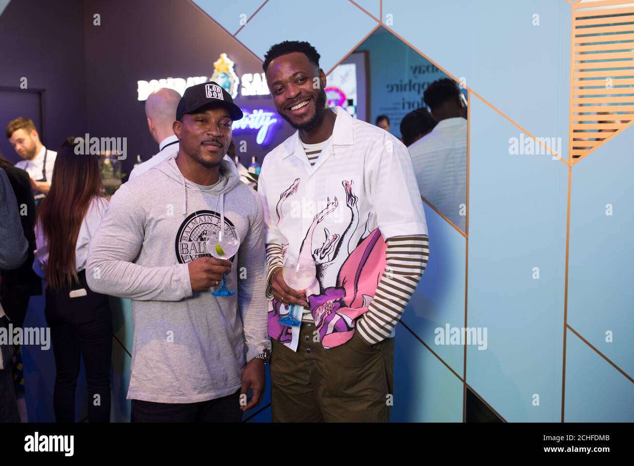 EDITORIAL USE ONLY Yinka Ilori and Ashley Walters at the Bombay Sapphire Stir Creativity Lounge at Frieze London, where the gin brand is launching a new Artificial Intelligence art collection in collaboration with artist Yinka Ilori. Stock Photo
