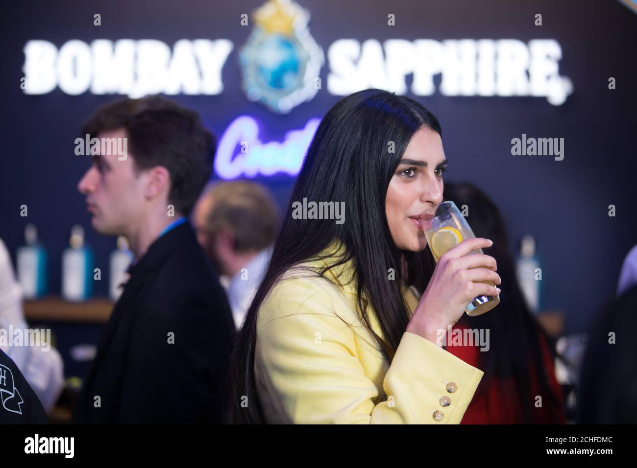 EDITORIAL USE ONLY Guests attend the Bombay Sapphire Stir Creativity Lounge at Frieze London, where the gin brand is launching a new Artificial Intelligence art collection in collaboration with artist Yinka Ilori. Stock Photo