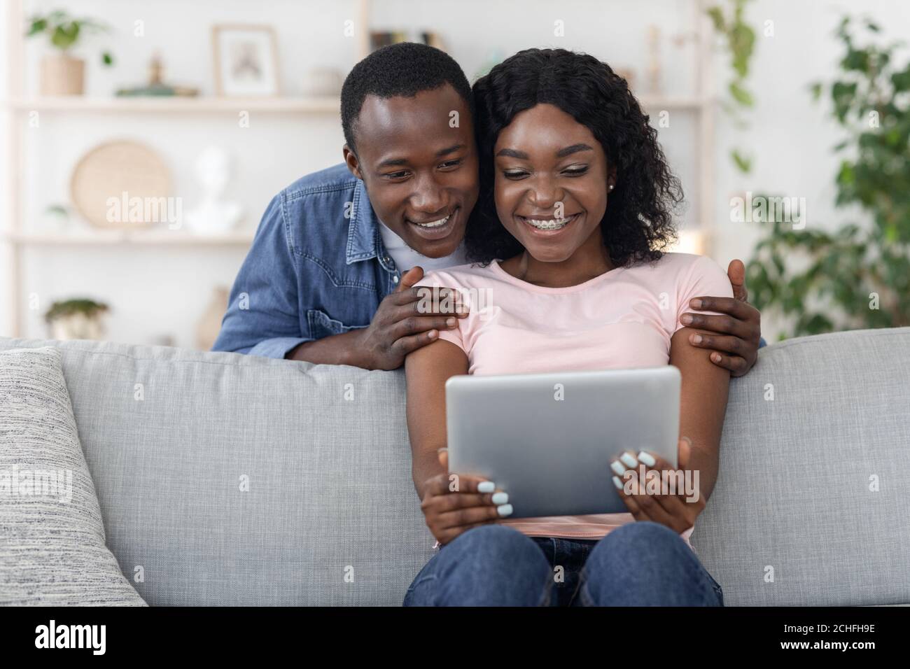 Happy lovers using digital tablet, checking new application Stock Photo