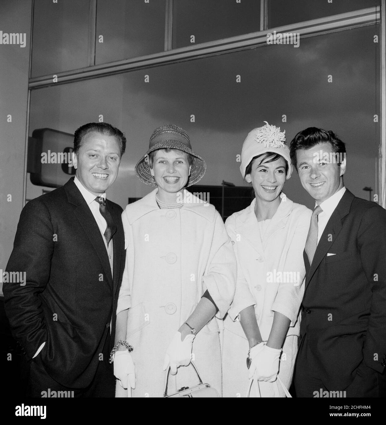 Home from the Berlin Film Festival with awards for their film 'The Angry Silence' are smiling actors Richard Attenborough (far left) and Bryan Forbes. Pictured with their wives, Mrs. Attenborough (Sheila Sim, left) and Mrs. Forbes (Nanette Newman). 6/7/1960 Stock Photo