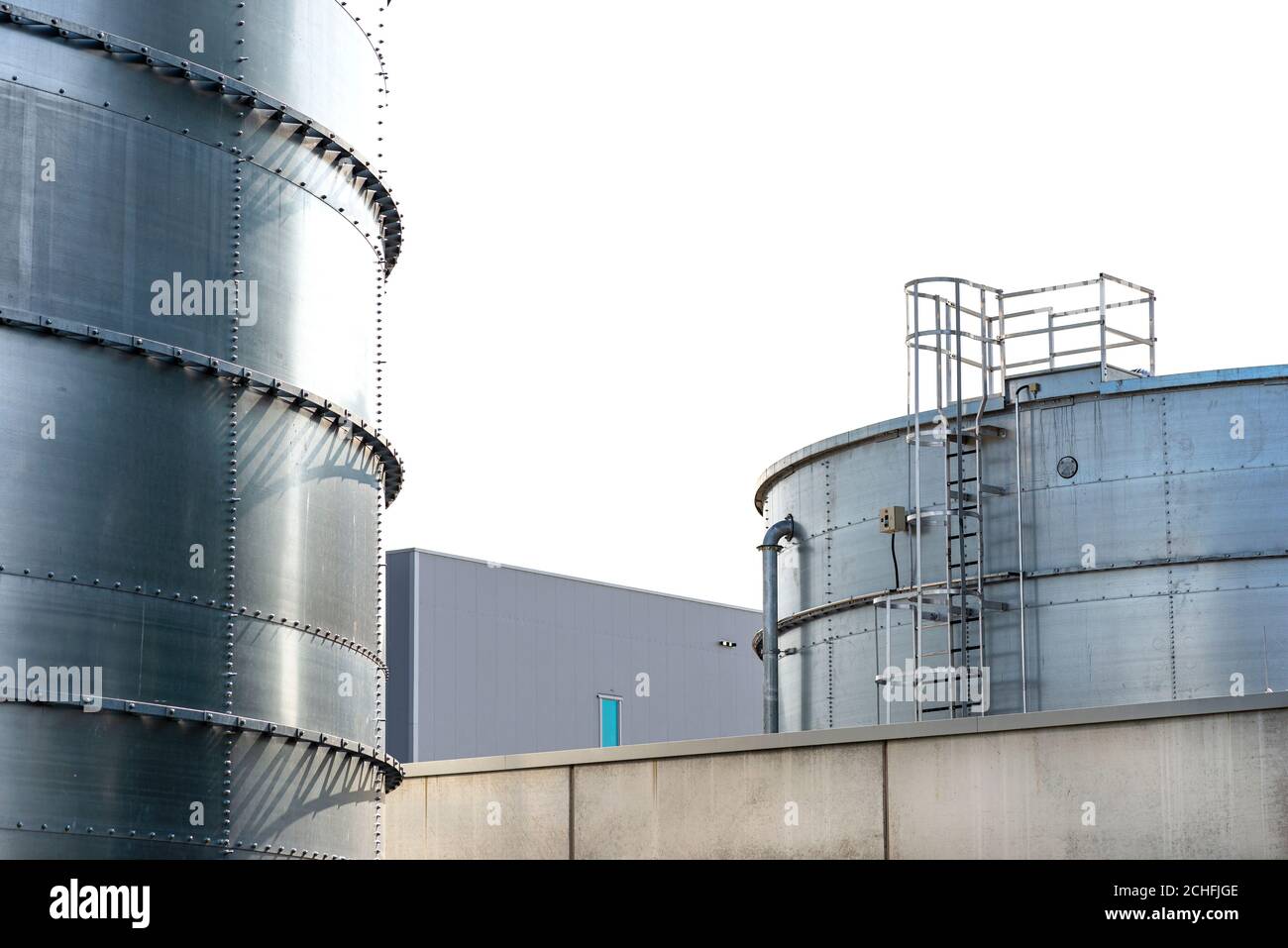 Steel industrial silos for liquids and solids standing in a factory