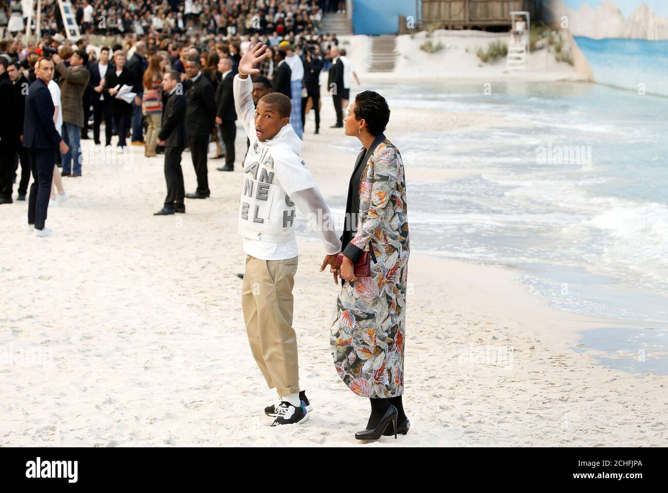 Pharrell Williams and Helen Lasichanh arrive to attend the Chanel Spring/Summer women's ready-to-wear collection show at the Grand Palais transformed as a beach scene during Paris Fashion Week Paris, France,