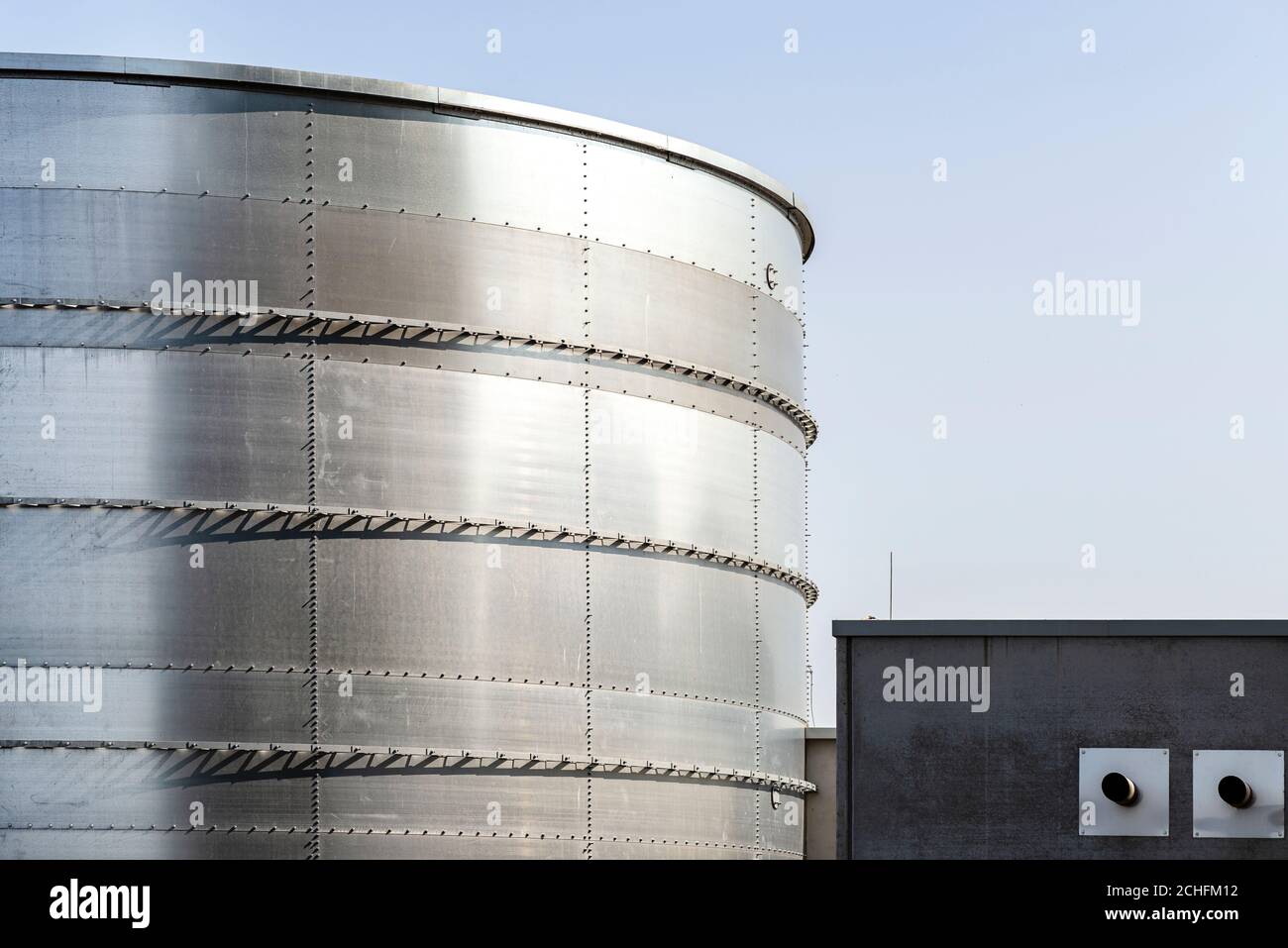 Steel industrial silos for liquids and solids standing in a factory