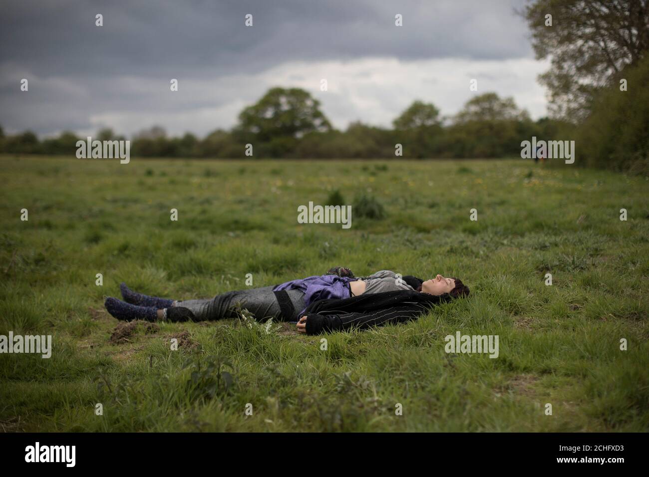 A protester sleeps in a field near the Stop HS2 protest camp near a development site for the High Speed 2 rail in Harefield, Britain April 28, 2019. REUTERS/Simon Dawson Stock Photo