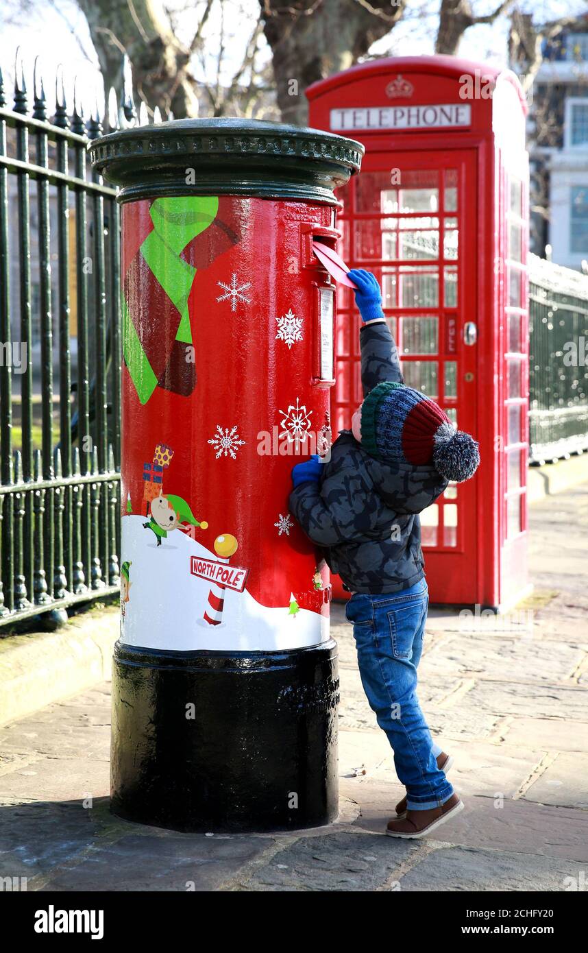 EDITORIAL USE ONLY Joshua Simpson, age 2, from Streatham, posts letters ...