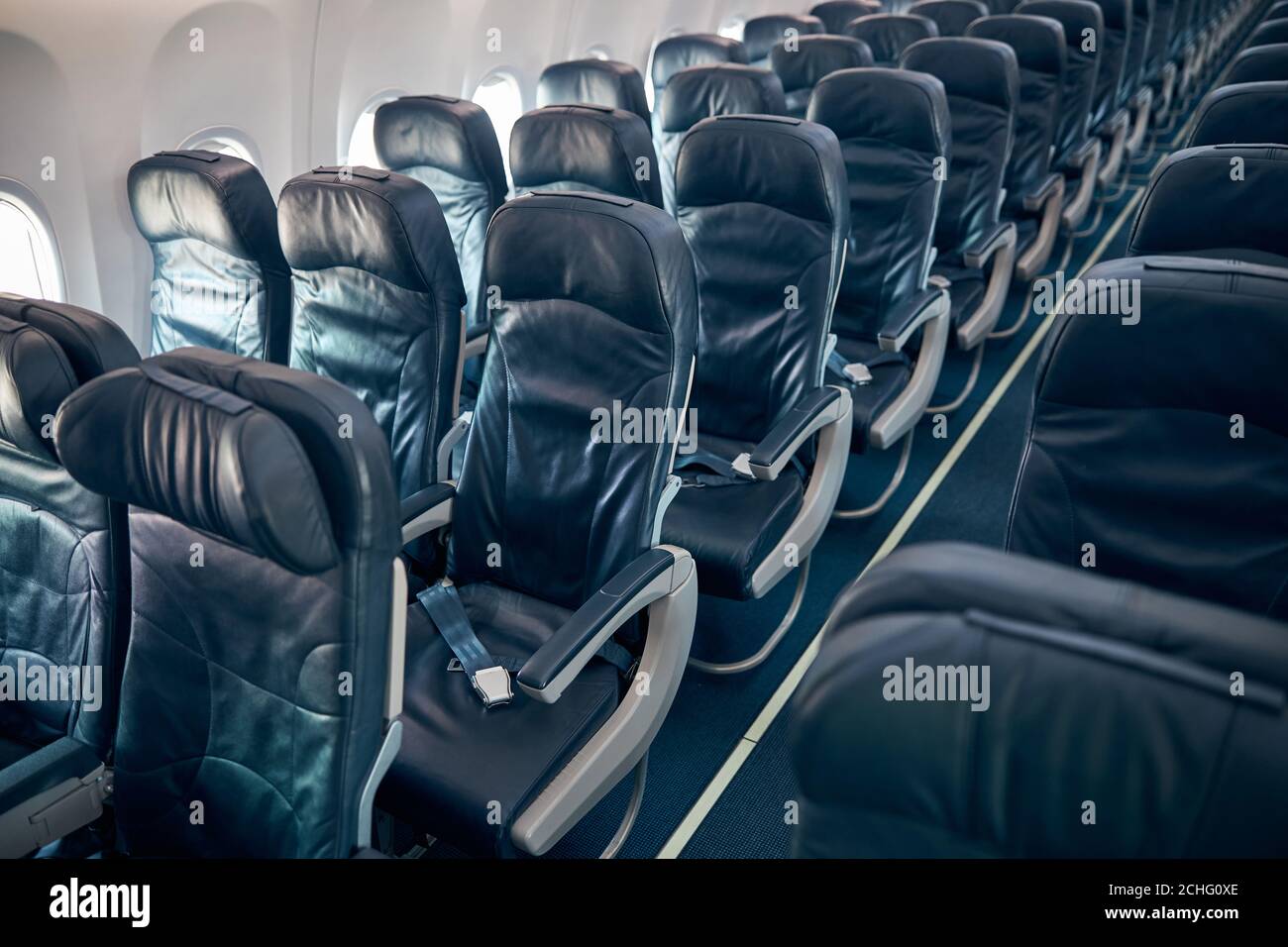 Interior of economy coach seats inside of passenger airplane Stock Photo -  Alamy