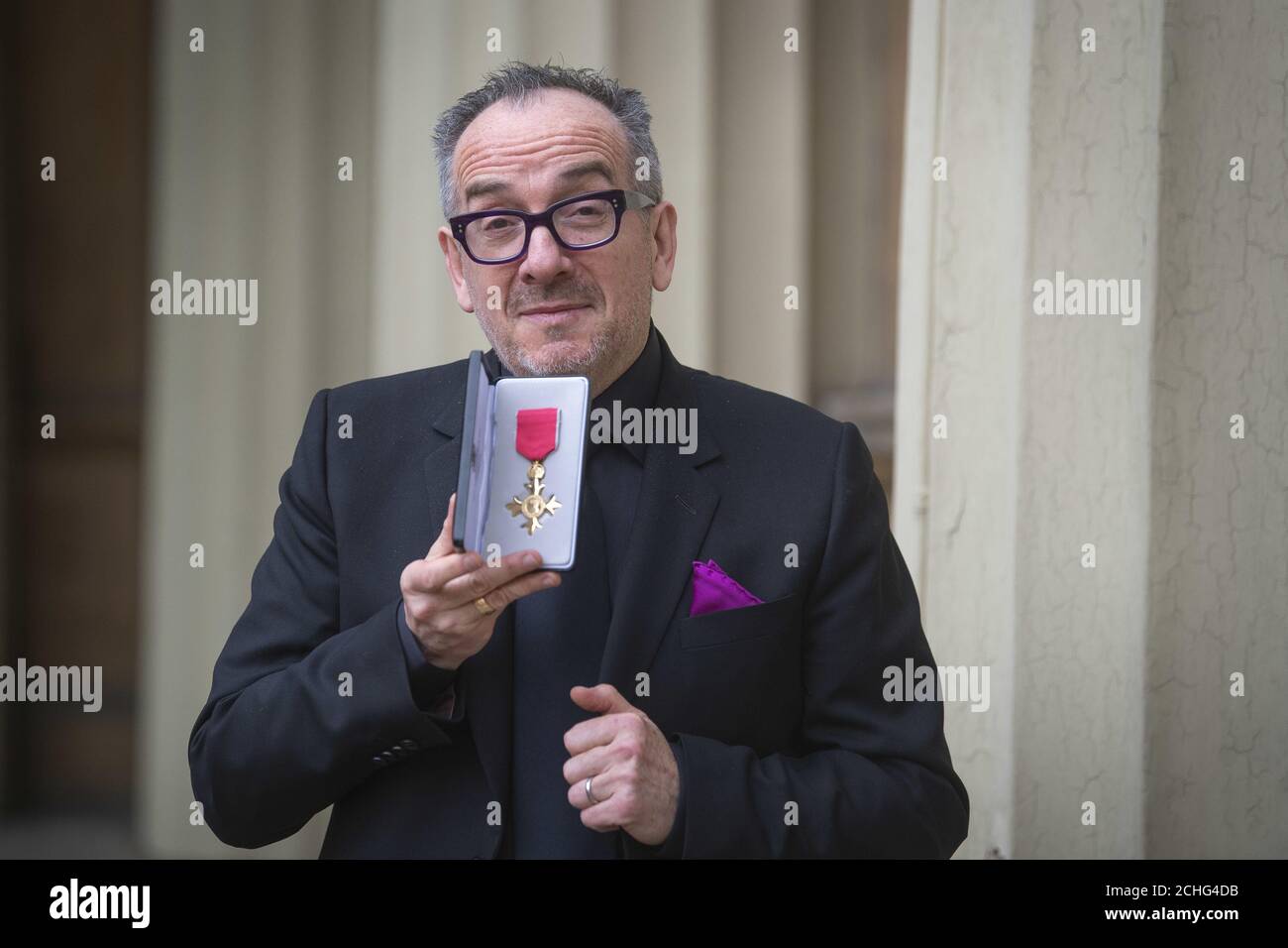 Elvis Costello, real name Declan McManus, with his OBE for services to music following an investiture ceremony at Buckingham Palace, London. PA Photo. Picture date: Friday February 14, 2020. See PA story ROYAL Investiture. Photo credit should read: Victoria Jones/PA Wire Stock Photo
