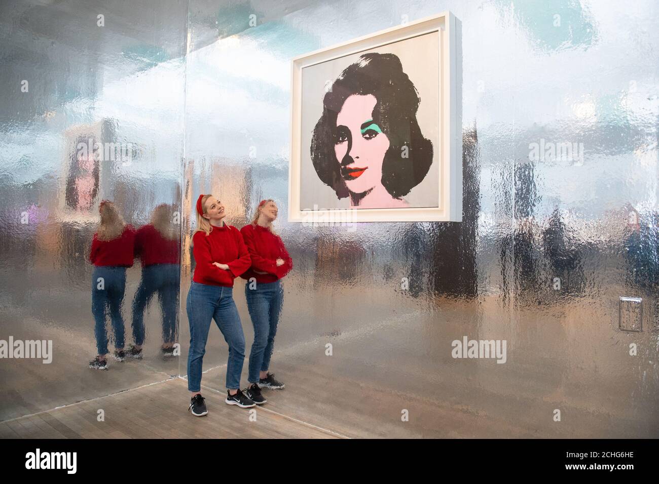 A Tate Modern gallery assistant views 'Silver Liz', 1963, at a press view of major new Andy Warhol exhibition at Tate Modern, London, which features classic pop art pieces and works never shown before in the UK. PA Photo. Picture date: Tuesday March 10, 2020. Photo credit should read: Dominic Lipinski/PA Wire Stock Photo