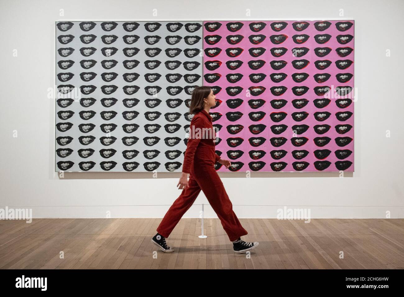 A Tate Modern gallery assistant views 'Marilyn Monroe's Lips' 1962, which is being exhibited for the first time in the UK at a press view of major new Andy Warhol exhibition at Tate Modern, London. PA Photo. Picture date: Tuesday March 10, 2020. Photo credit should read: Dominic Lipinski/PA Wire Stock Photo