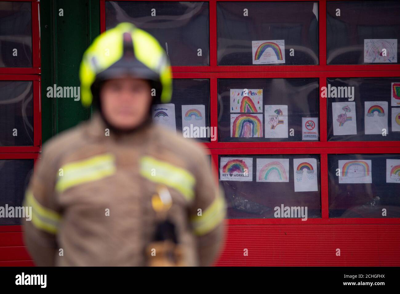 Firefighters observe a minute's silence outside Bournbrook Community fire station in Birmingham, in memory of their colleagues that lost their lives in the line of duty. Stock Photo