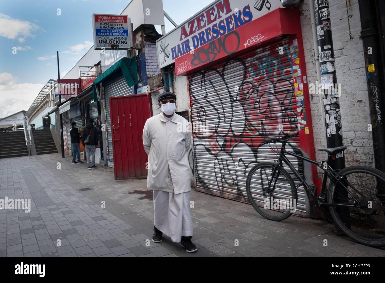 Members of the Islamic community in Whitechapel in east London go about their daily business during the holy month of Ramadan as the UK continues in lockdown to help curb the spread of the coronavirus. Stock Photo