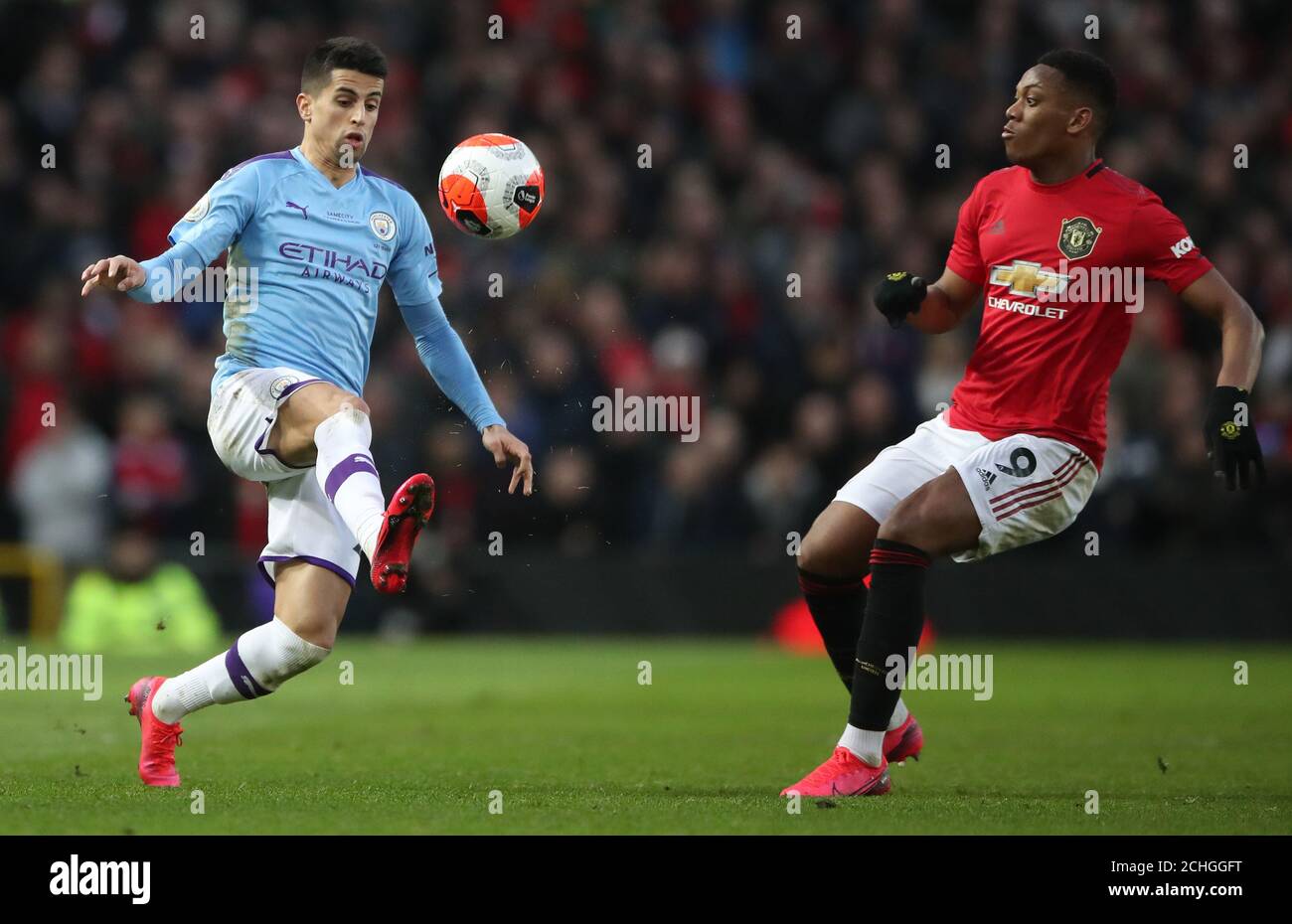 Manchester City's Joao Cancelo controls ball away from Manchester United's Anthony Martial during the Premier League match at Old Trafford, Manchester. Stock Photo