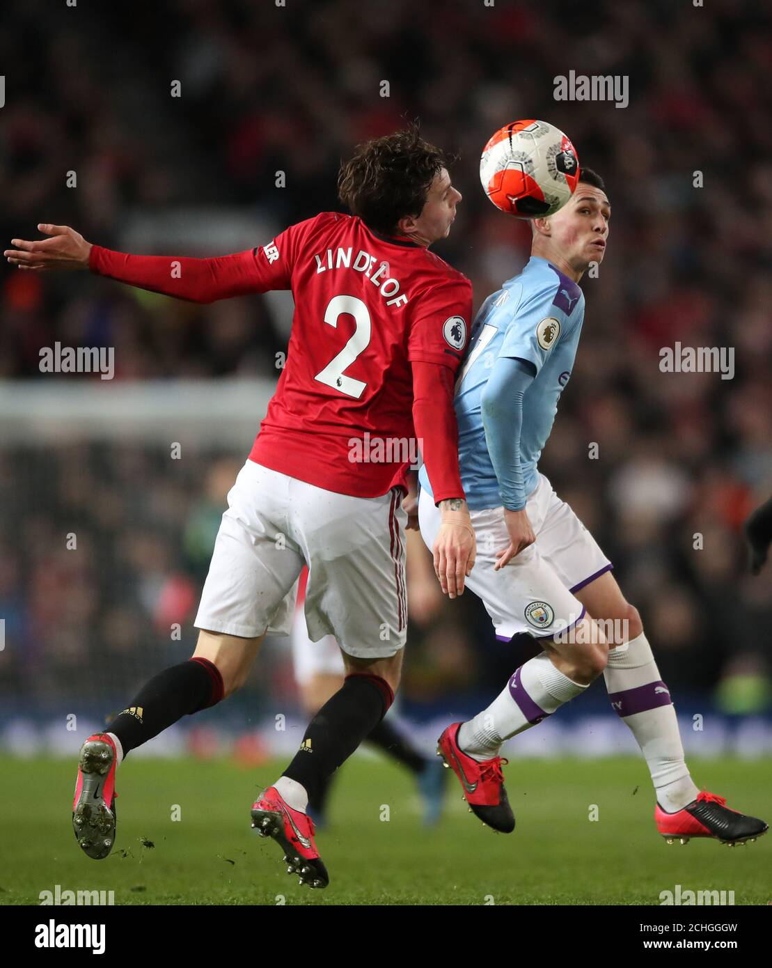 Manchester City's Phil Foden battles to win the ball off Manchester United's Victor Lindelof during the Premier League match at Old Trafford, Manchester. Stock Photo