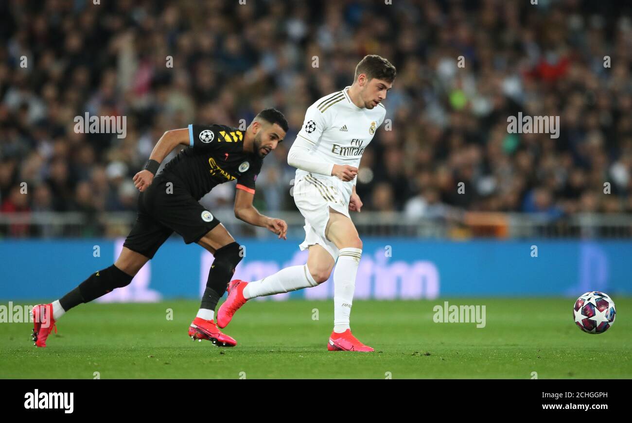 Real Madrid's Federico Valverde turns away from Manchester City's Riyad Mahrez during the UEFA Champions League round of 16 first leg match at the Santiago Bernabeu, Madrid. Stock Photo