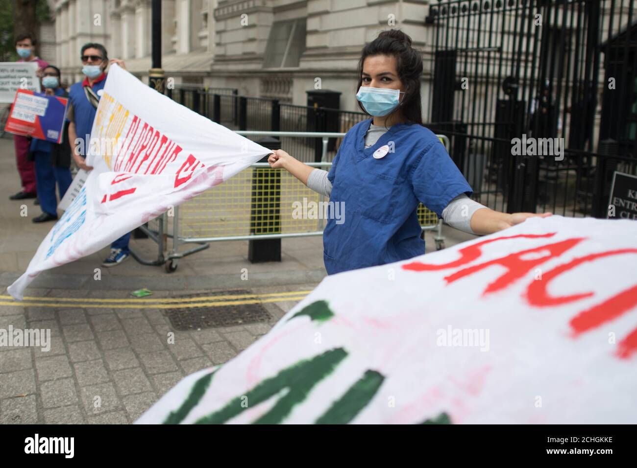 Nurse Ameera Sheikh protests outside Downing Street, London, demanding a pay rise, real protection against COVID-19 and and the release of Public Health England's review into BAME NHS staff's deaths. PA Photo. Picture date: Wednesday June 3, 2020. See PA story HEALTH Coronavirus. Photo credit should read: Stefan Rousseau/PA Wire Stock Photo