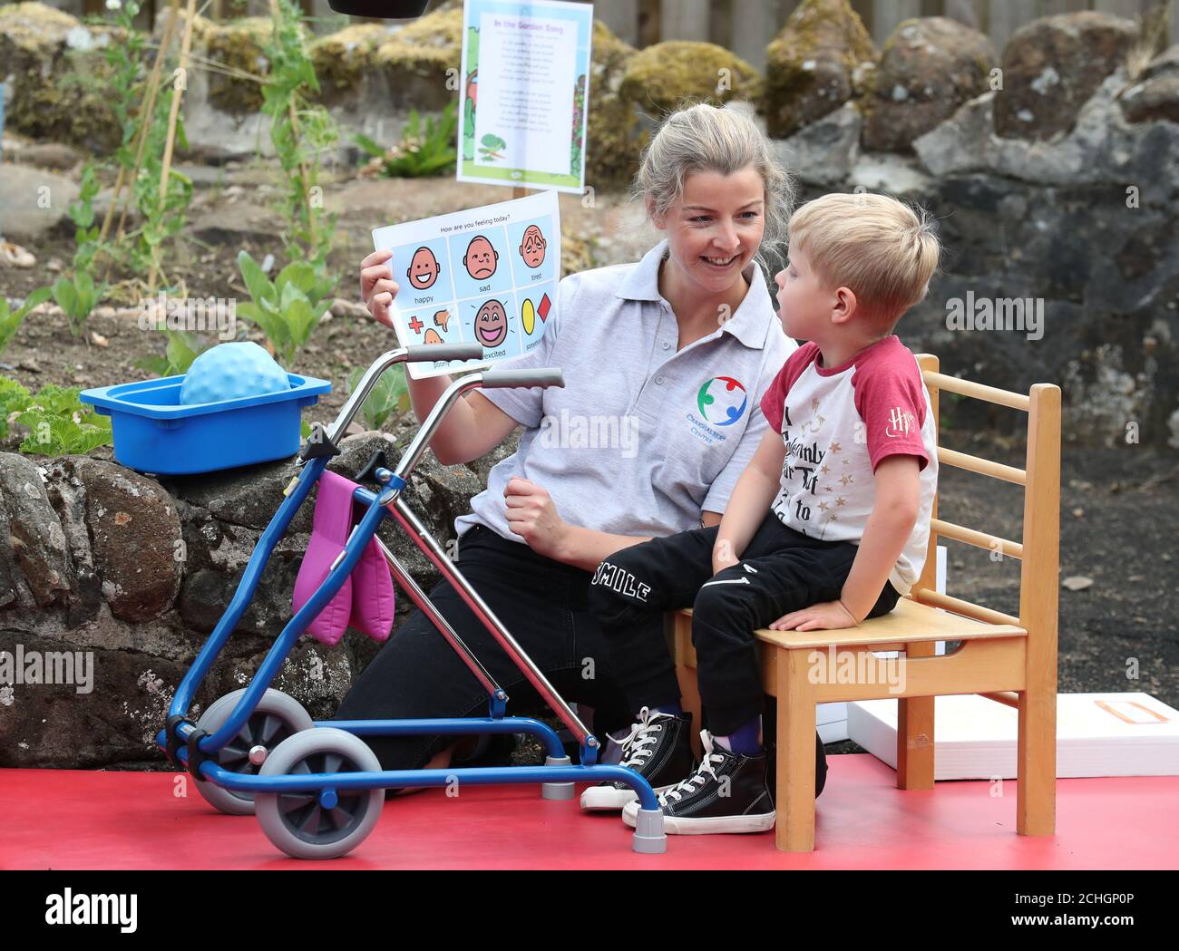 Specialist Physiotherapist Leah Honohan with Oliver Cunningham during a shared theraplay session in the outside therapy area at the Craighalbert Centre. Coronavirus adaptations have been installed at the Scottish Centre for Children with Motor Impairments, Craighalbert Centre, Cumbernauld, as Scotland continues gradually lifting coronavirus lockdown measures. Stock Photo