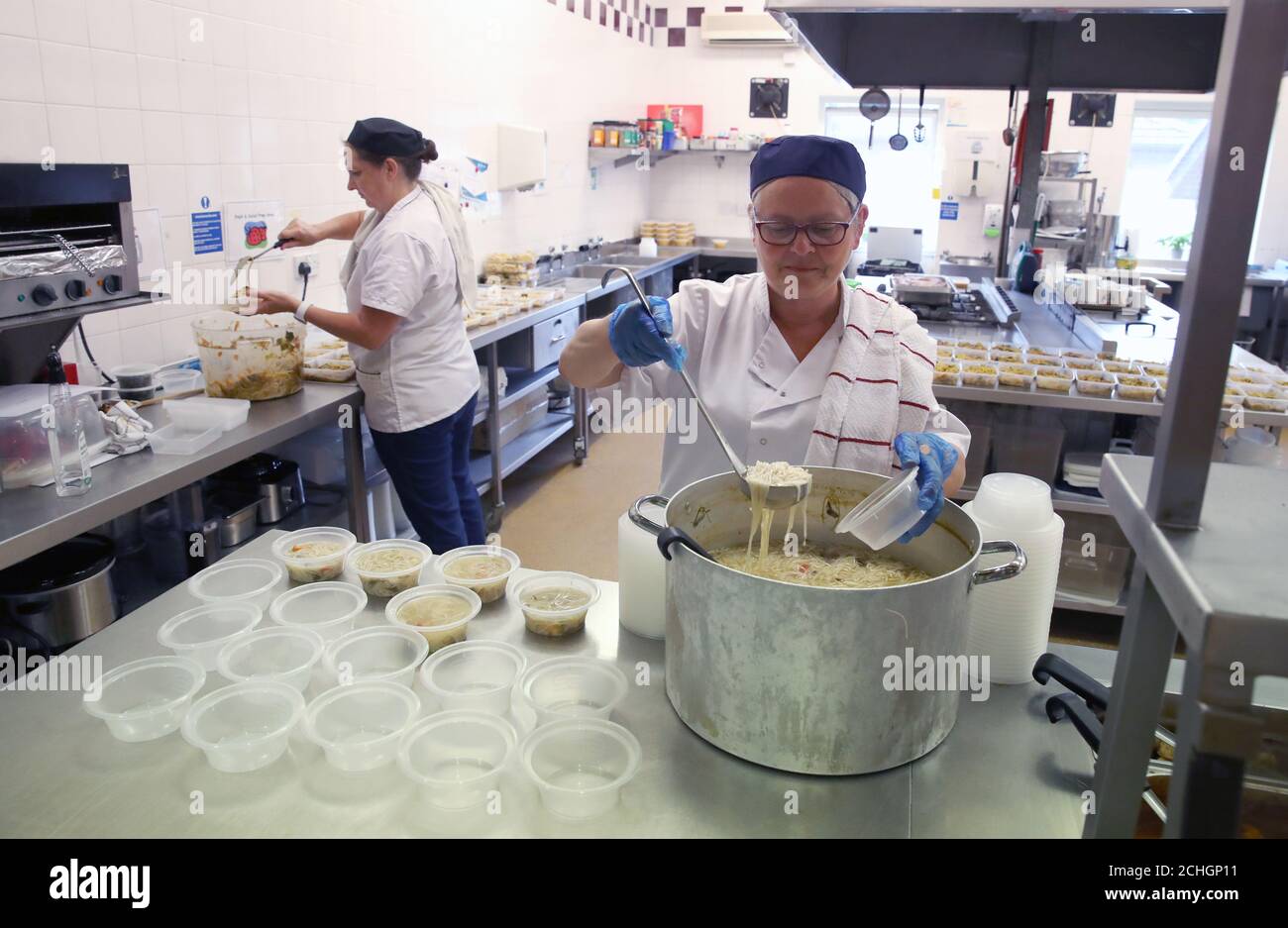 Embargoed to 0001 Monday June 22 Cooks Jan McLaughlin (left) and Frances Park use the Craighalbert centre facilities to produce meals for distribution by local organisations supporting vulnerable families in the local community. Coronavirus adaptations have been installed at the Scottish Centre for Children with Motor Impairments, Craighalbert Centre, Cumbernauld, as Scotland continues gradually lifting coronavirus lockdown measures. Stock Photo