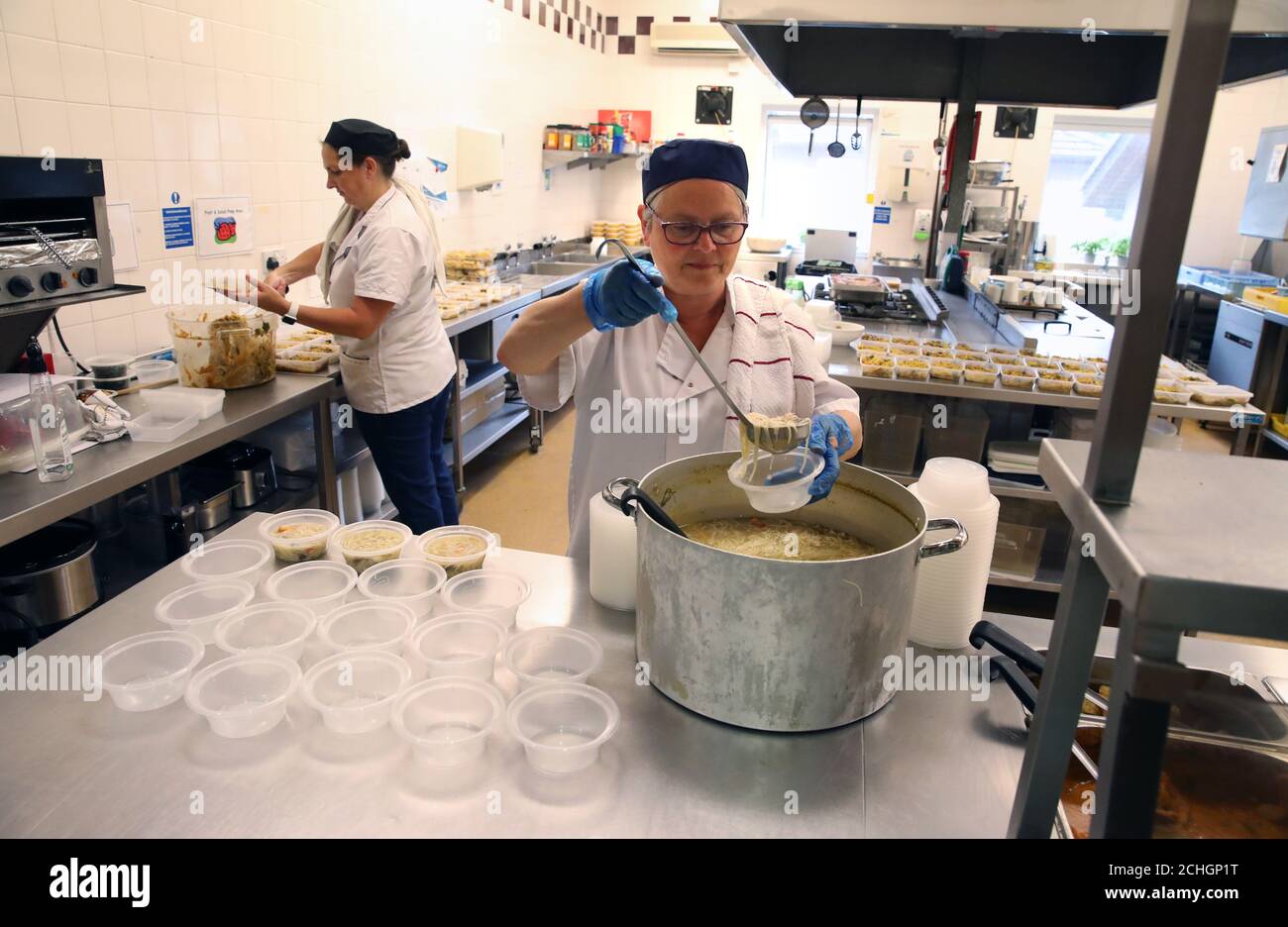 Cooks Jan McLaughlin (left) and Frances Park using the Craighalbert centre facilities to produce meals for distribution by local organisations supporting vulnerable families in the local community. Coronavirus adaptations have been installed at the Scottish Centre for Children with Motor Impairments, Craighalbert Centre, Cumbernauld, as Scotland continues gradually lifting coronavirus lockdown measures. Stock Photo